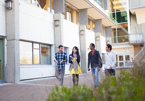 A group of young people walking outside a building